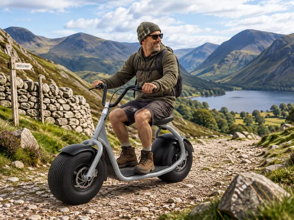 Man riding a Pro Scoot electric scooter on a hillside trail