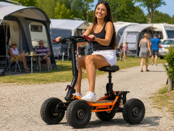 woman on orange scooter, caravan park
Woman riding an orange Pro Scoot electric scooter through a caravan park
