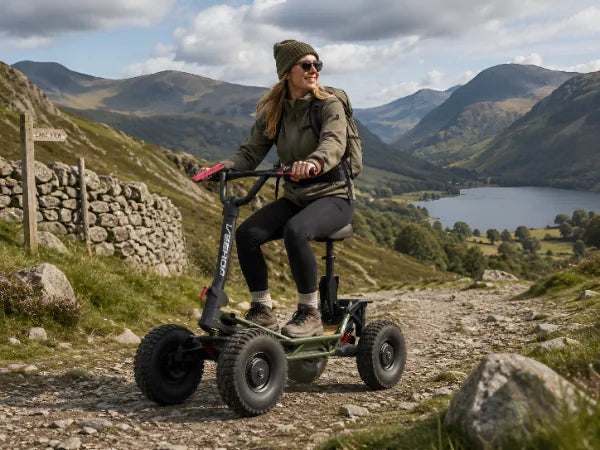 Woman riding VEEHOP electric scooter on hillside trail.